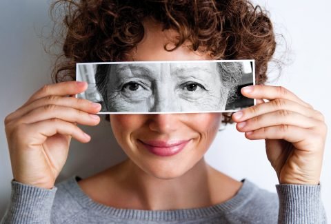 Young-woman-holding-image-of-old-woman-in-front-of-her-Mar-13-p144